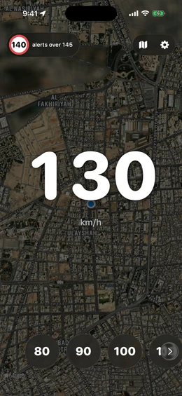 Speed readout of 130 km/h over a live satellite map of the city, with a 140 road-sign chip alerting over 145
